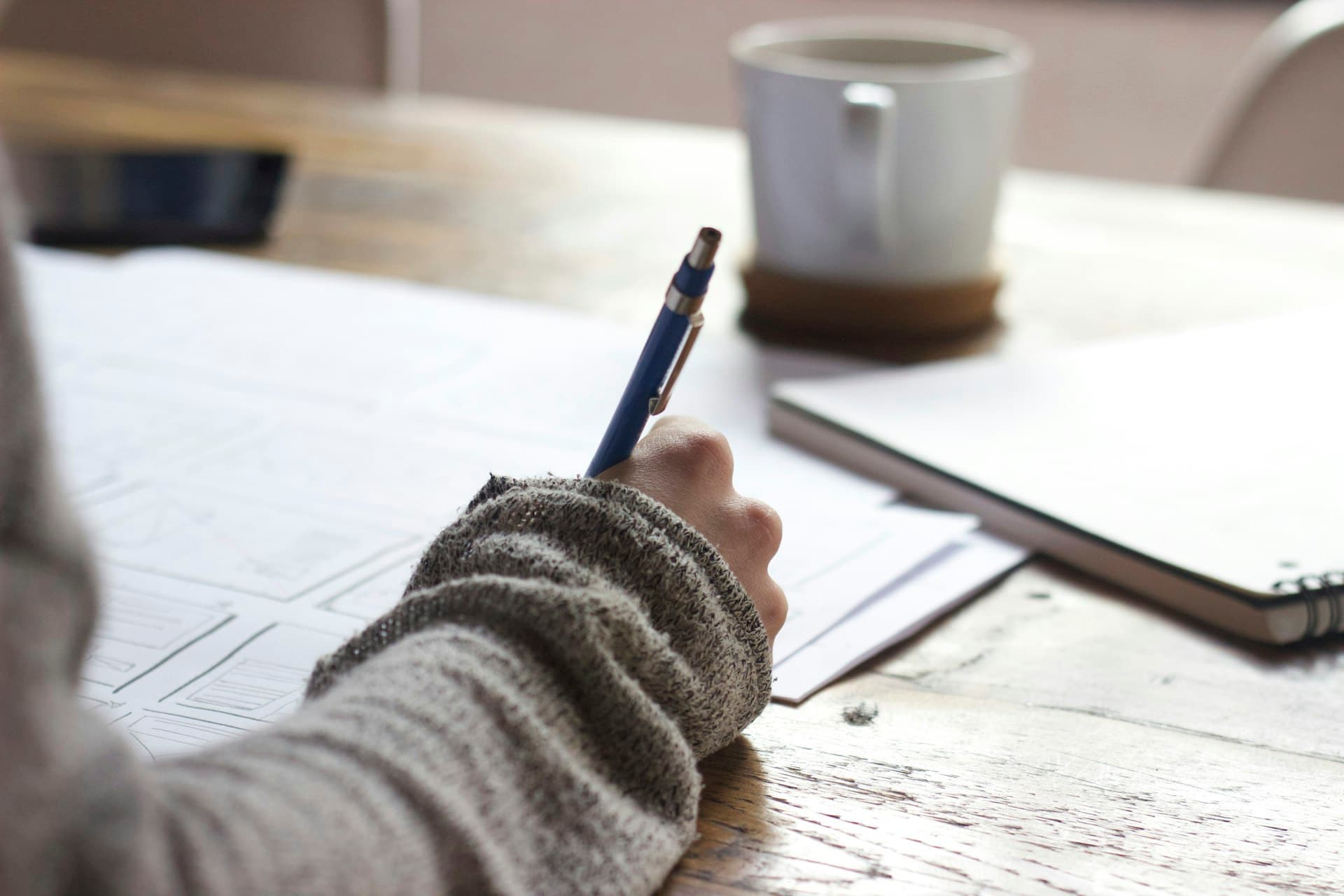 Student studying with notebooks and notes